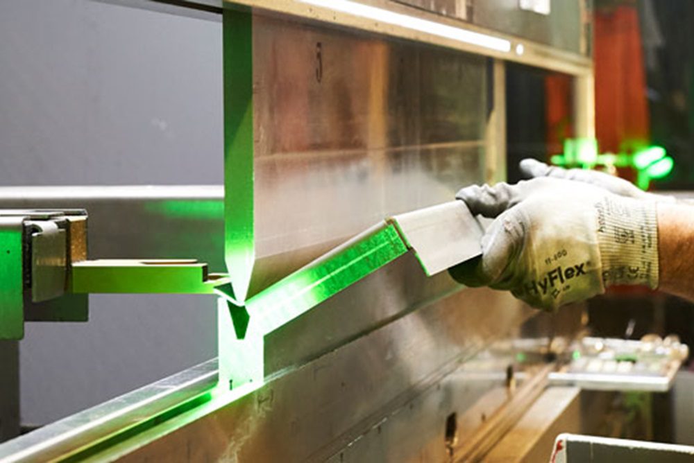 worker using machine to form metal